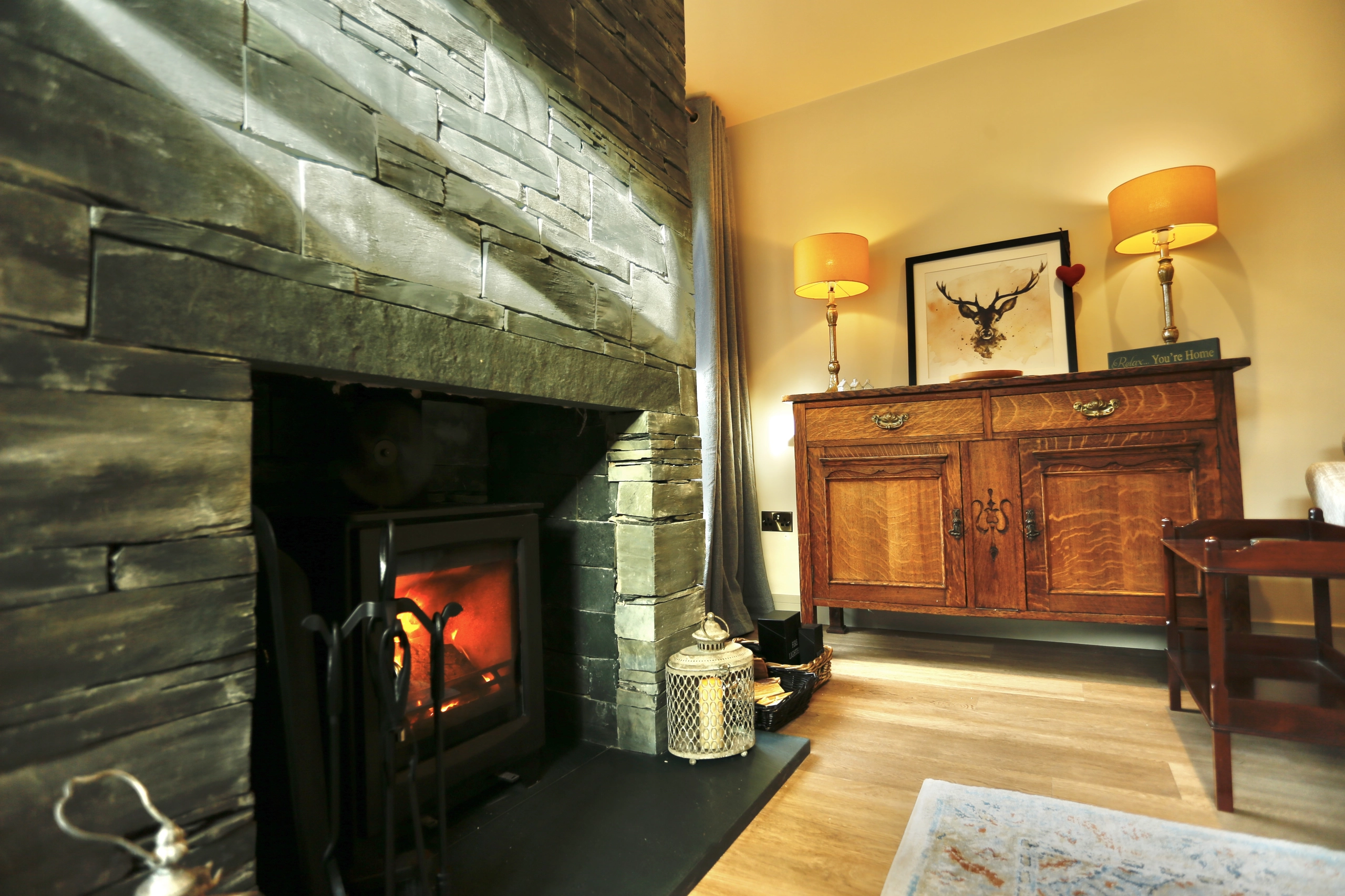 a fireplace with a fire in it at Havendale Accessible Holiday Cottage