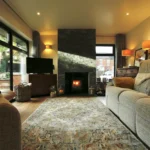 a living room with a fireplace and a couch at Havendale Accessible Holiday Cottage