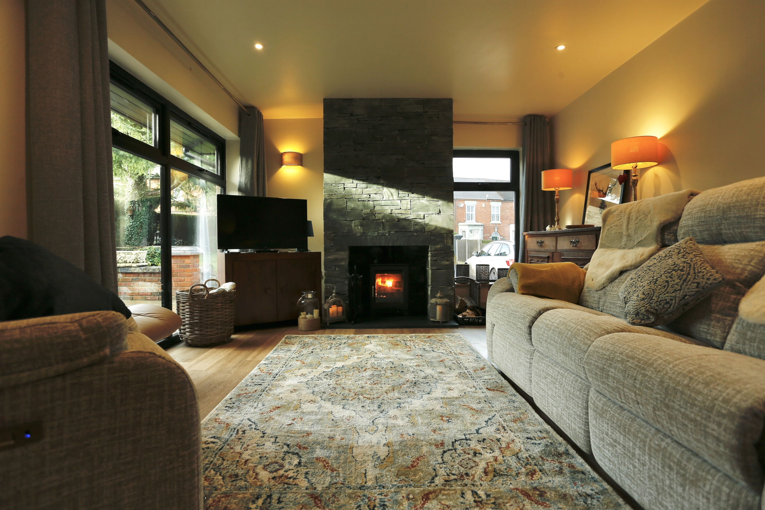 a living room with a fireplace and a couch at Havendale Accessible Holiday Cottage