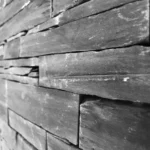 a black and white photo of a wall made of wood at Havendale Accessible Holiday Cottage