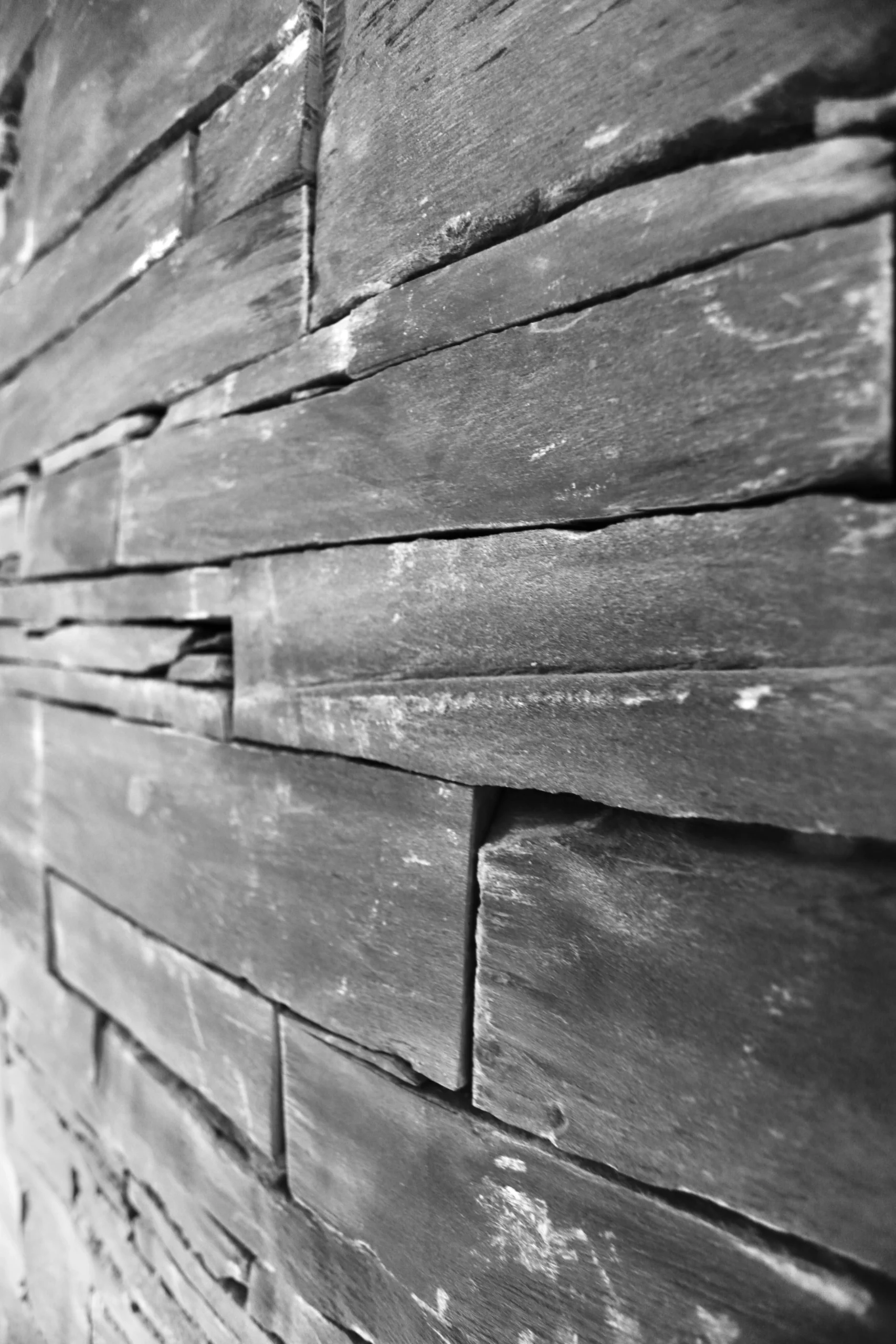 a black and white photo of a wall made of wood at Havendale Accessible Holiday Cottage