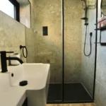 a bathroom with a sink and a mirror at Havendale Accessible Holiday Cottage