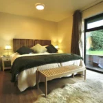 a bed with a white blanket at Havendale Accessible Holiday Cottage