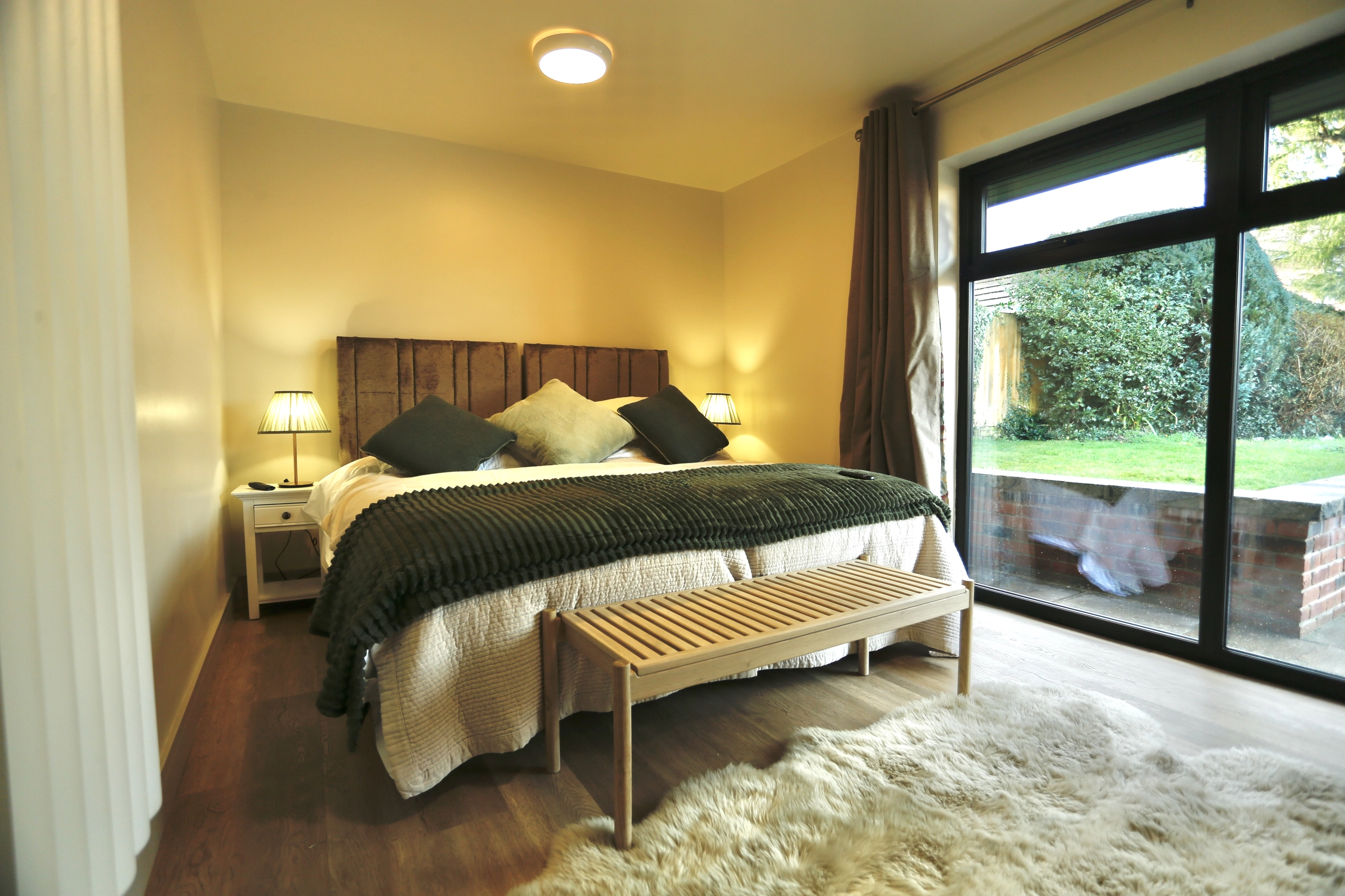 a bed with a white blanket at Havendale Accessible Holiday Cottage