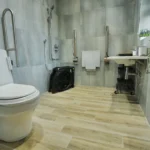 a bathroom with a toilet and a sink at Havendale Accessible Holiday Cottage