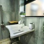 a bathroom with a sink and a mirror at Havendale Accessible Holiday Cottage