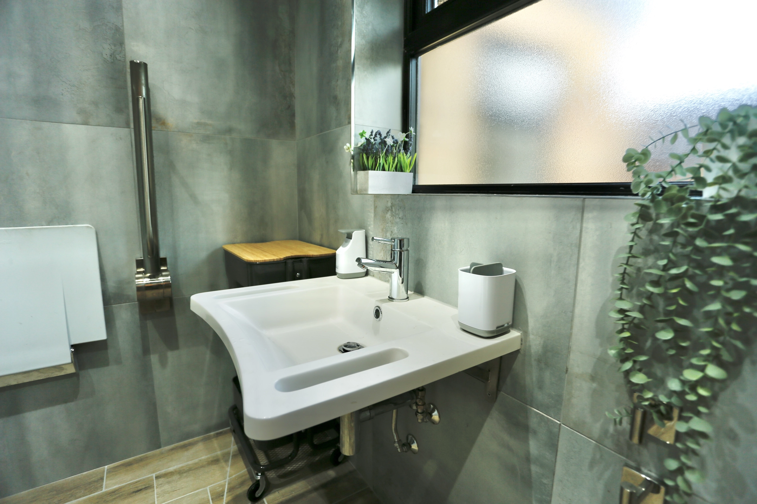 a bathroom with a sink and a mirror at Havendale Accessible Holiday Cottage