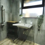 a bathroom with a sink and mirror at Havendale Accessible Holiday Cottage