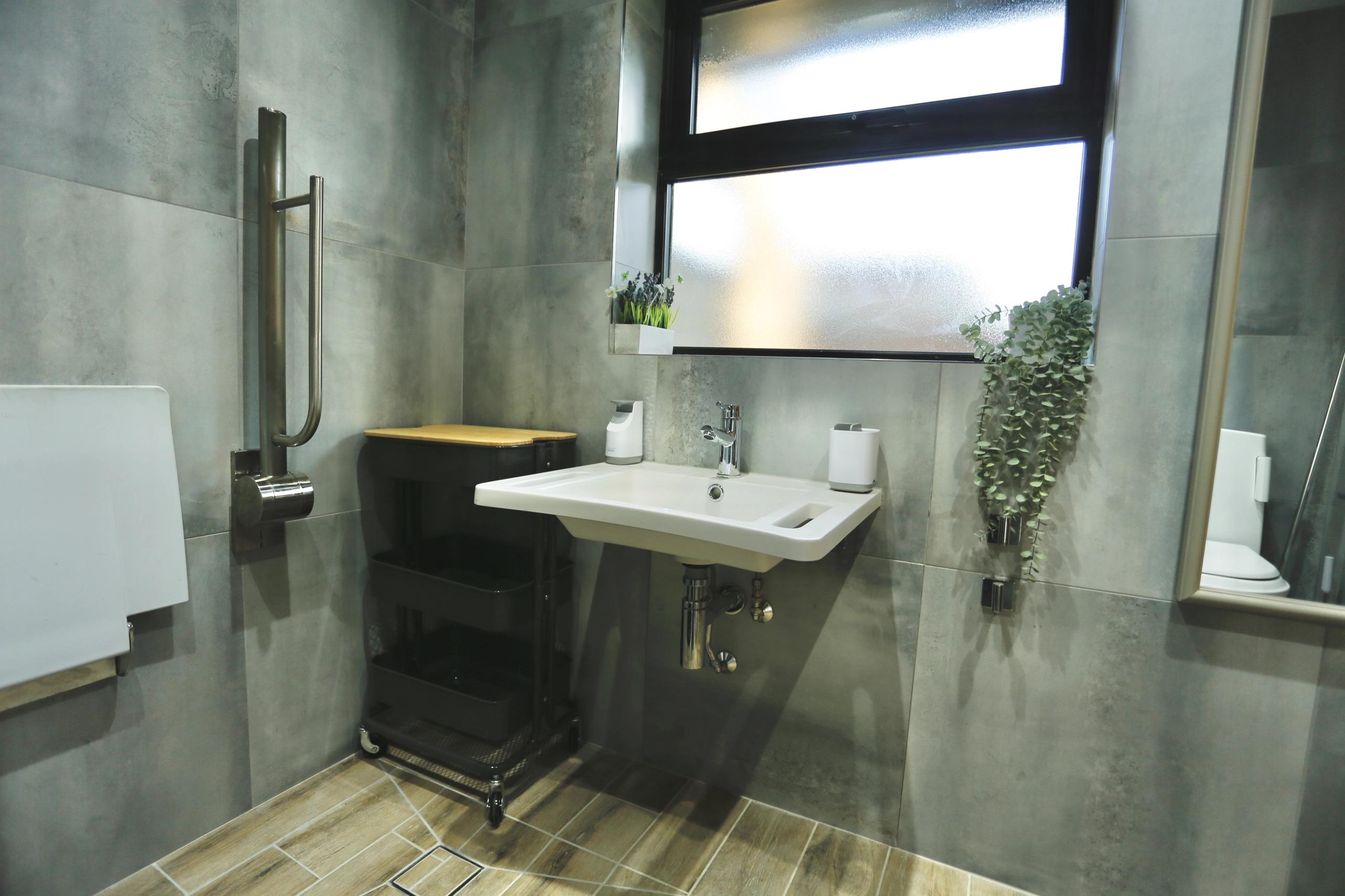 a bathroom with a sink and mirror at Havendale Accessible Holiday Cottage