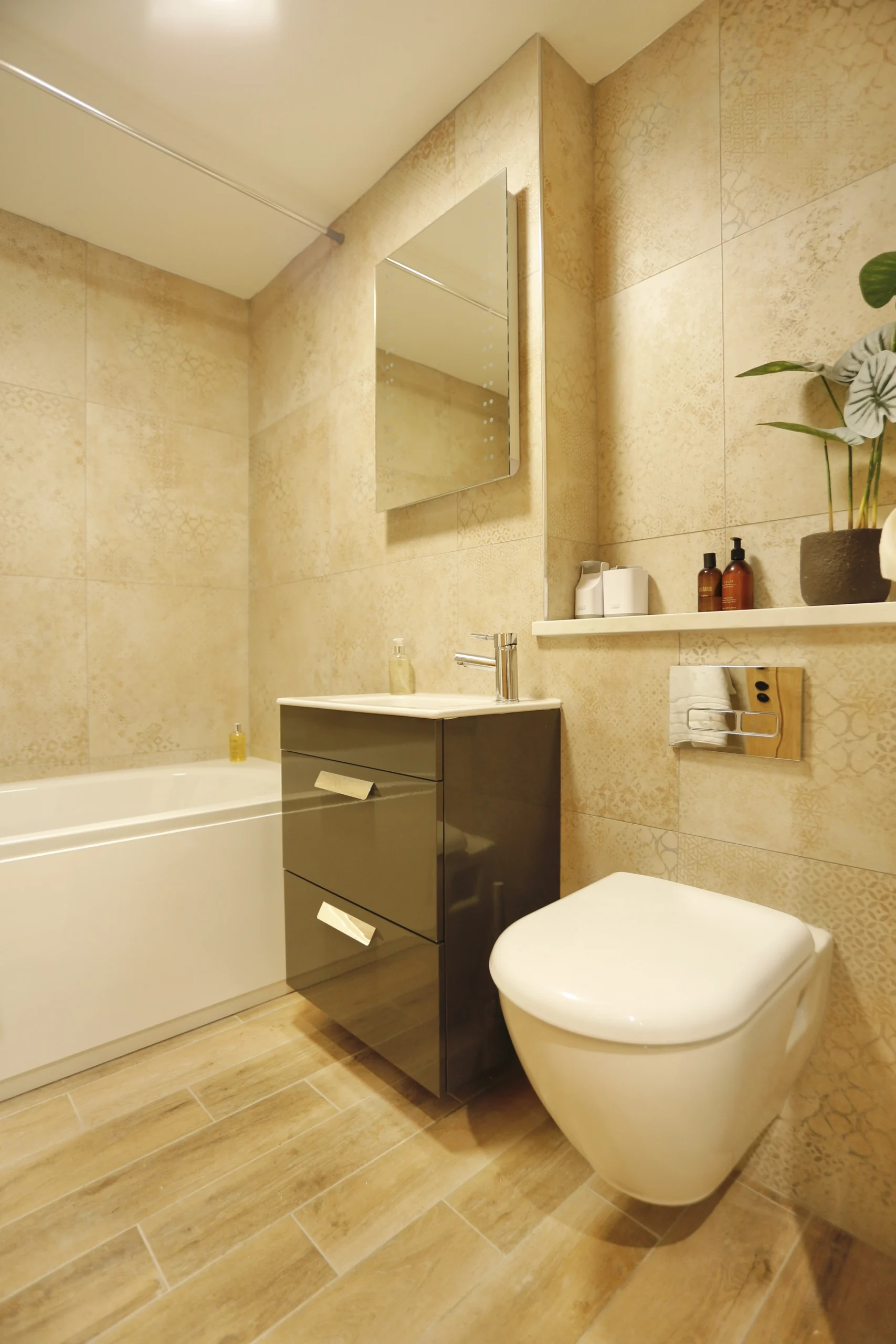 a bathroom with a toilet, sink, and mirror at Havendale Accessible Holiday Cottage