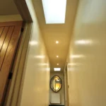 a long hallway with a skylight above at Havendale Accessible Holiday Cottage