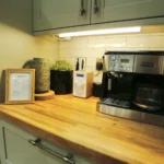 a kitchen counter with a coffee maker and a microwave at Havendale Accessible Holiday Cottage