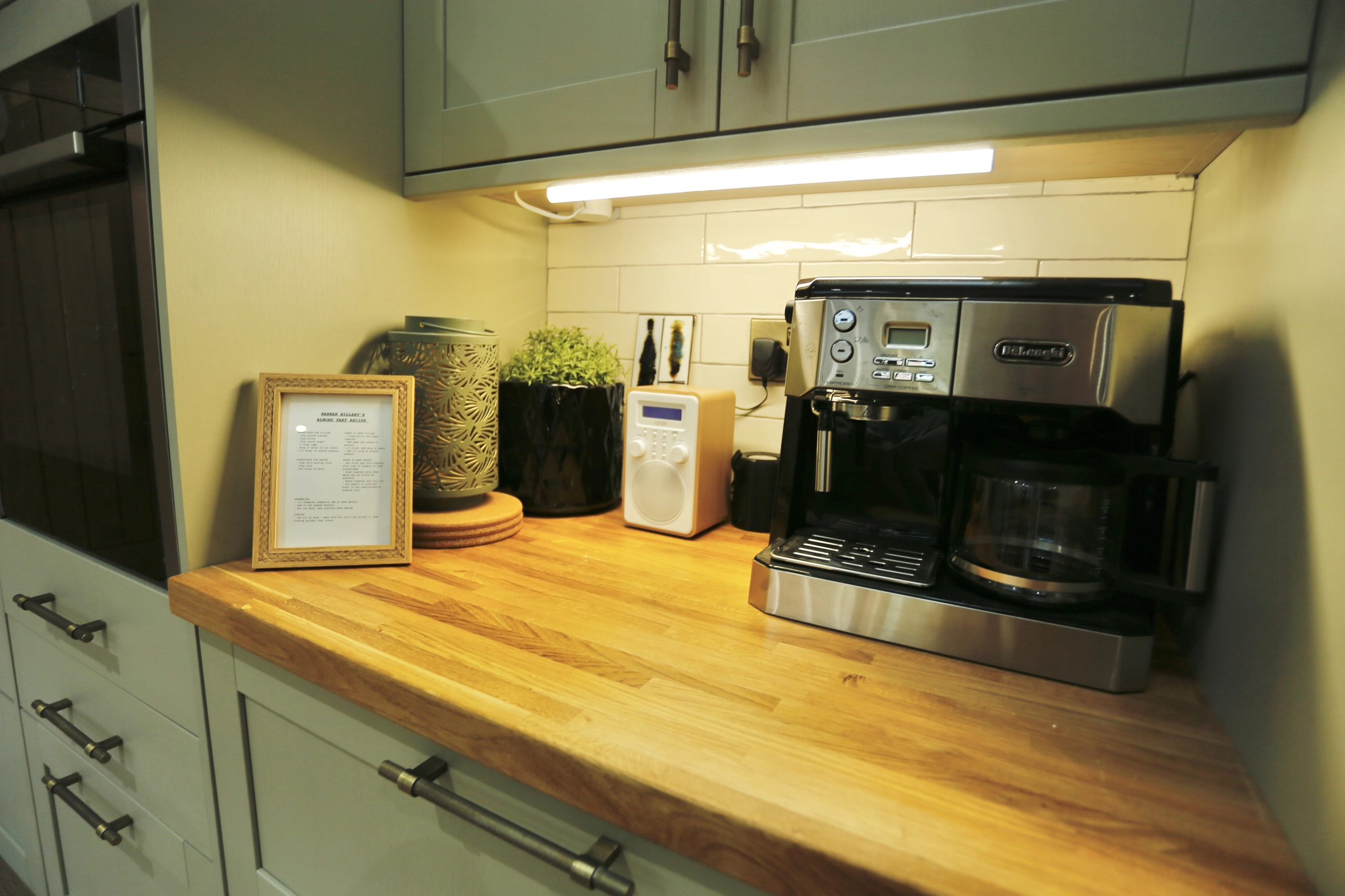 a kitchen counter with a coffee maker and a microwave at Havendale Accessible Holiday Cottage