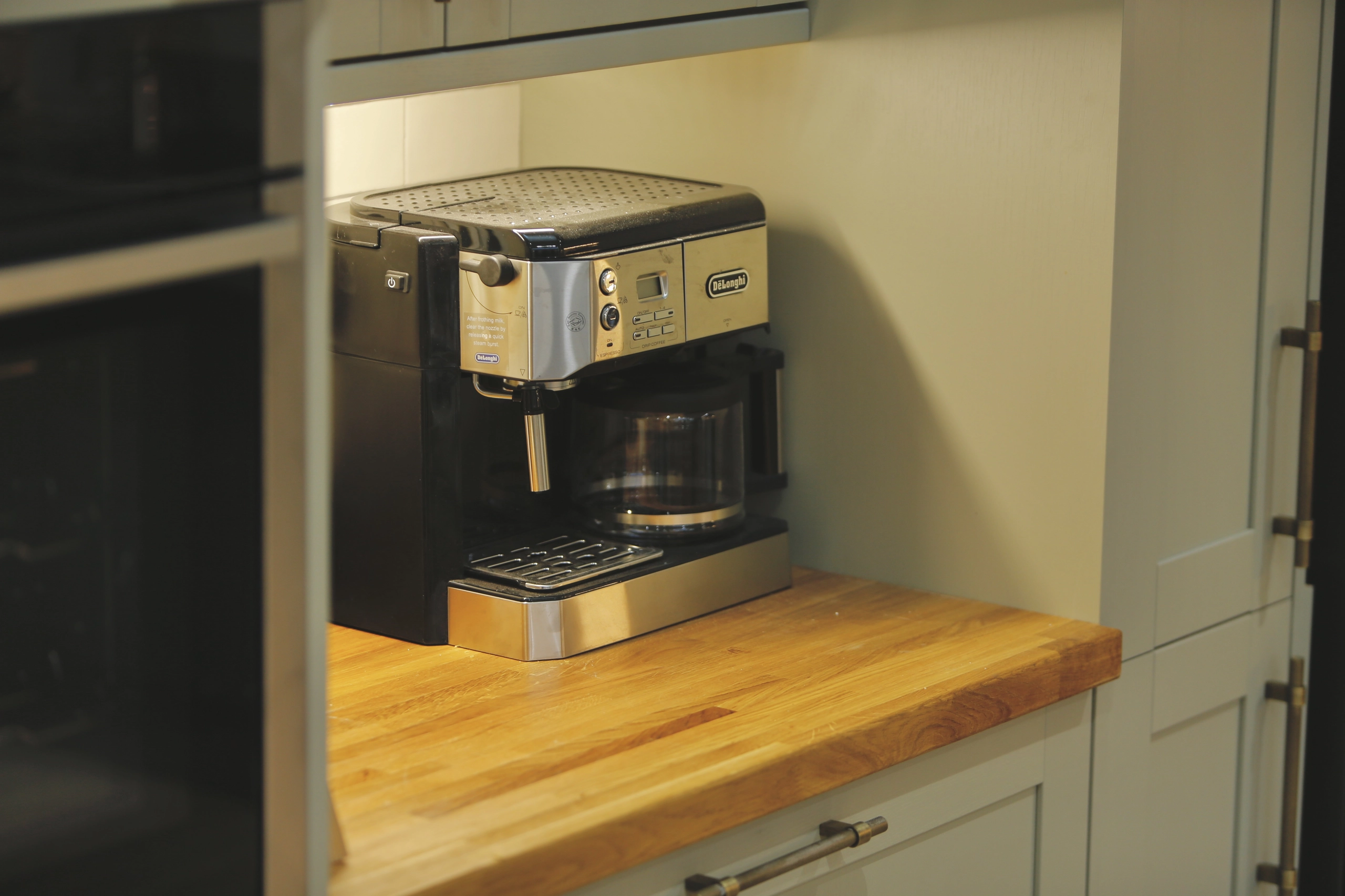 a coffee machine sitting on top of a wooden counter at Havendale Accessible Holiday Cottage