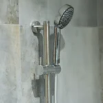 a shower with a shower head and a shower arm at Havendale Accessible Holiday Cottage