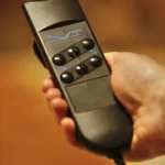 a person holding a remote control device at Havendale Accessible Holiday Cottage