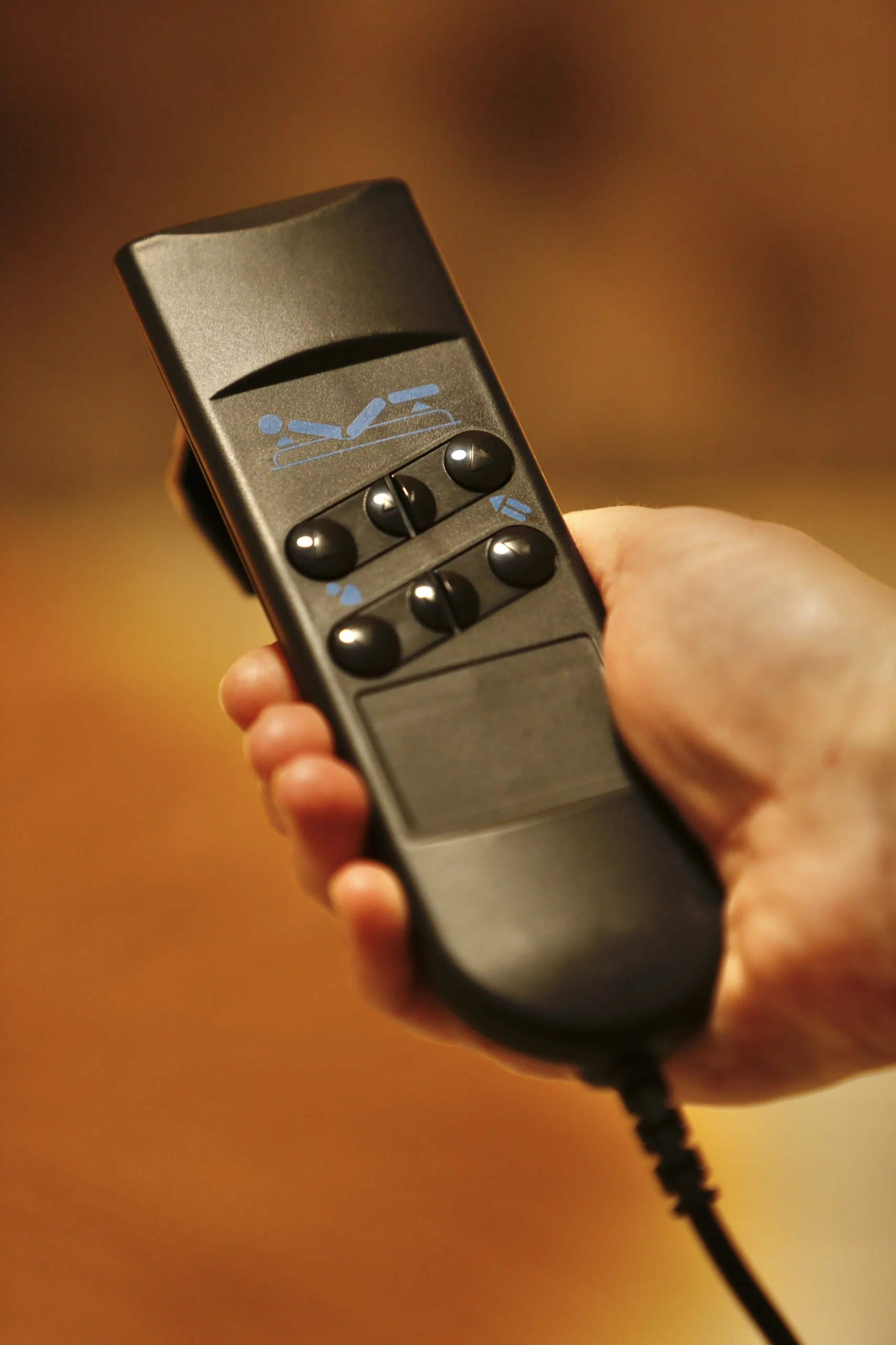 a person holding a remote control device at Havendale Accessible Holiday Cottage