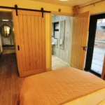a bedroom with a bed and a mirror at Havendale Accessible Holiday Cottage