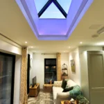 a living room with a skylight and a couch at Havendale Accessible Holiday Cottage