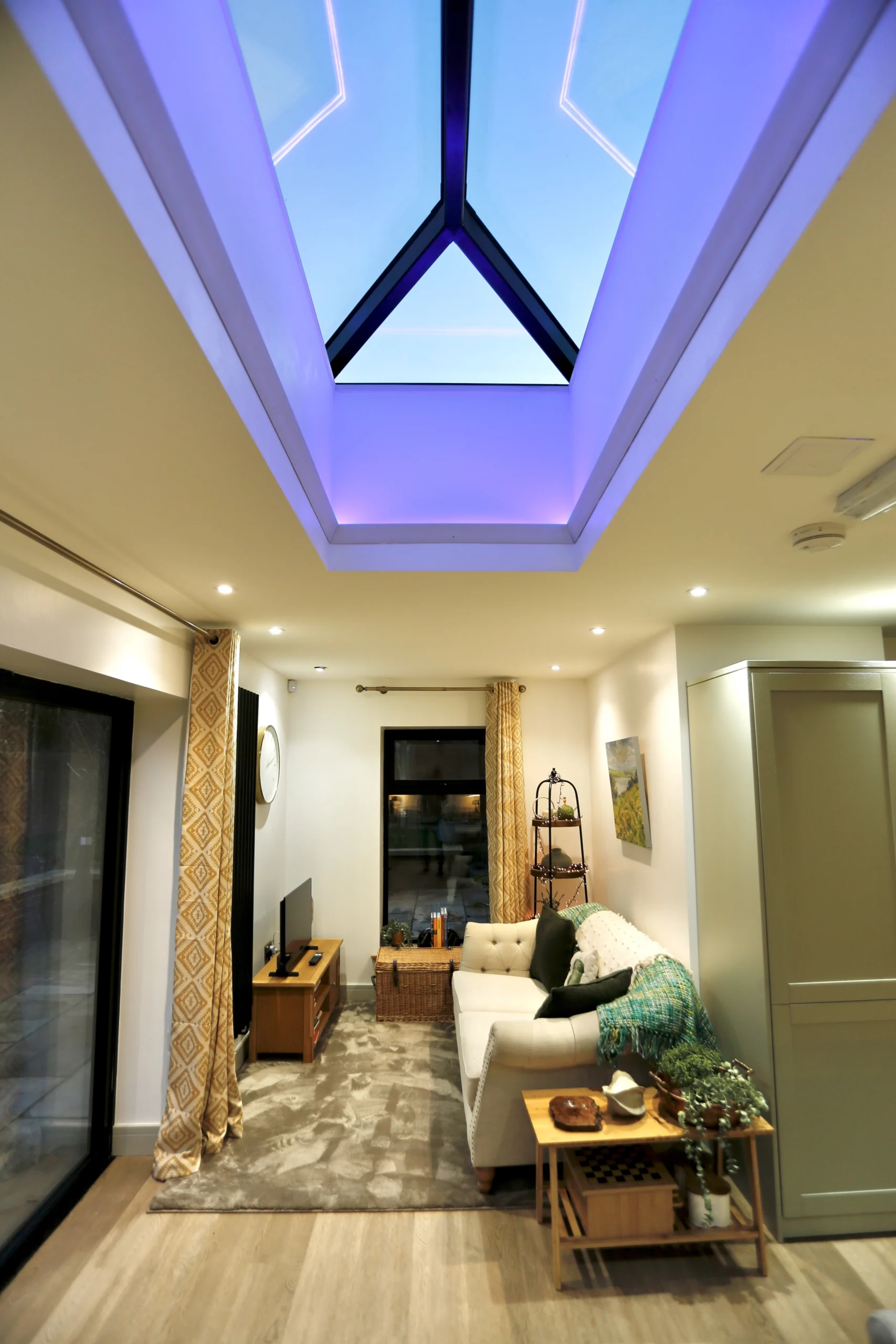 a living room with a skylight and a couch at Havendale Accessible Holiday Cottage