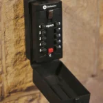 a black phone is on a brick wall at Havendale Accessible Holiday Cottage