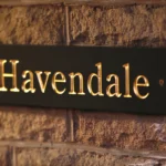 a sign on a brick wall that says havenia at Havendale Accessible Holiday Cottage
