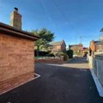 a brick wall in a residential area at Havendale Accessible Holiday Cottage