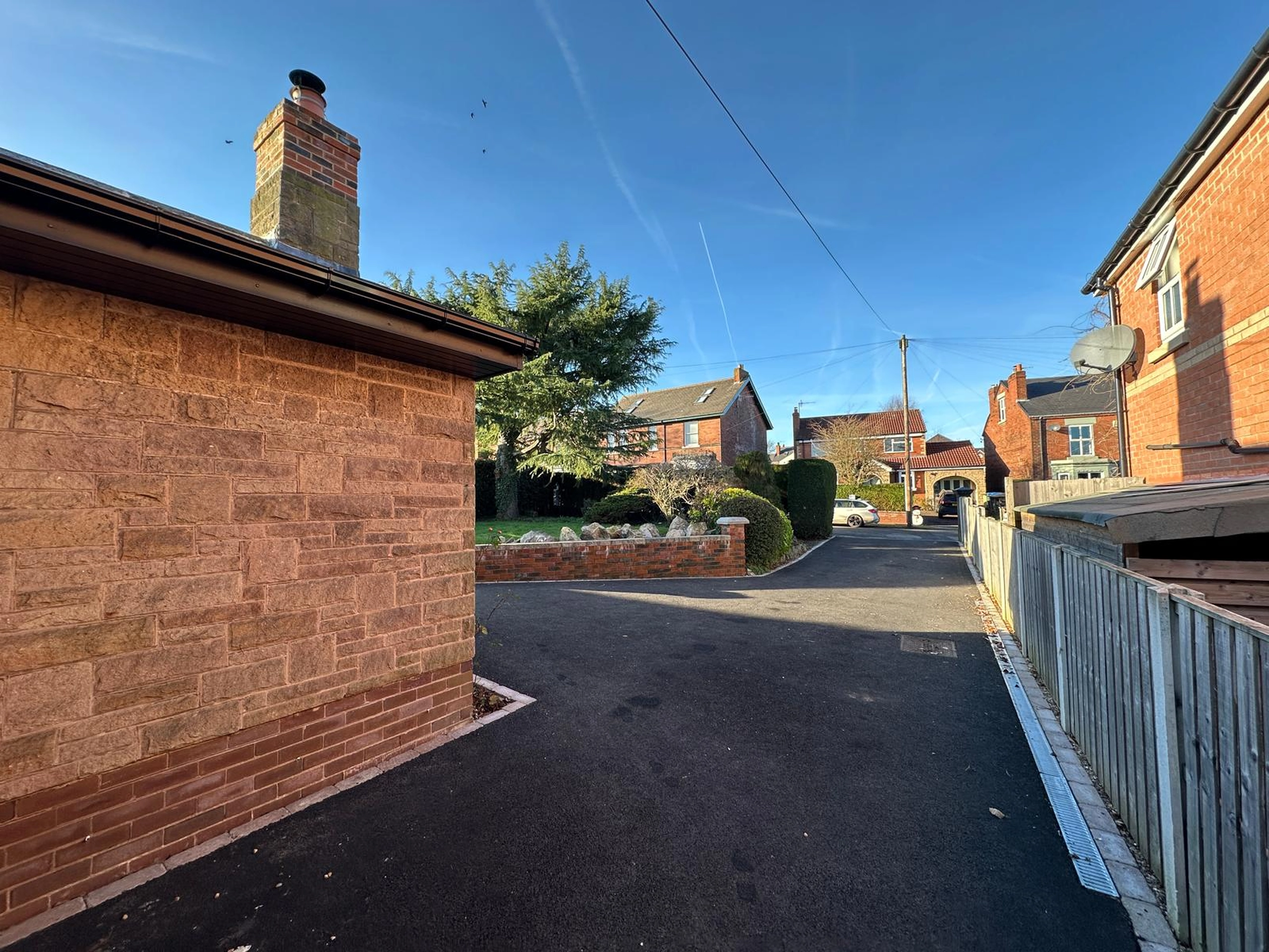 a brick wall in a residential area at Havendale Accessible Holiday Cottage