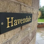 a black and gold plaque with the word Havendale on it at Havendale Accessible Holiday Cottage