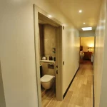 a bathroom with a toilet and internal view Havendale Accessible Holiday Cottage