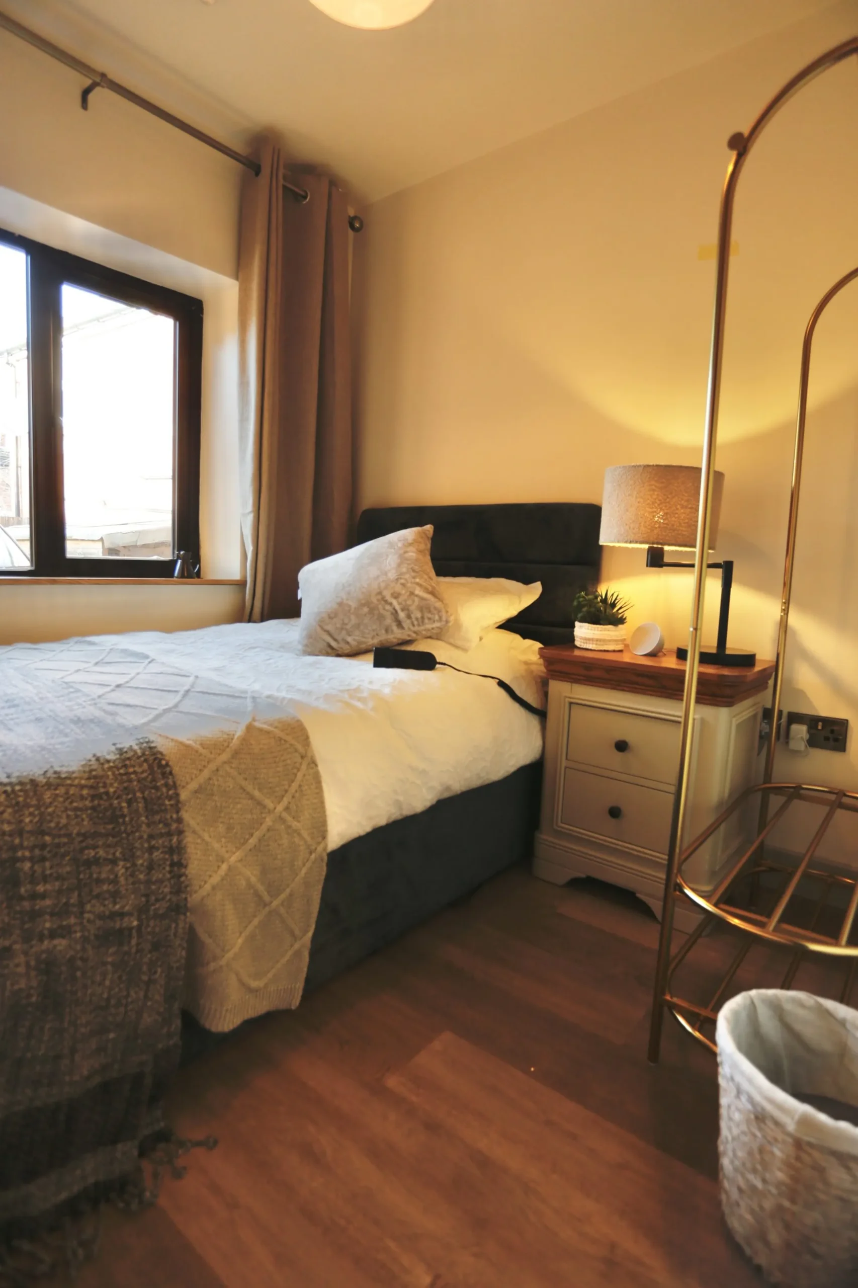 a bed with a white comforter at Havendale Accessible Holiday Cottage