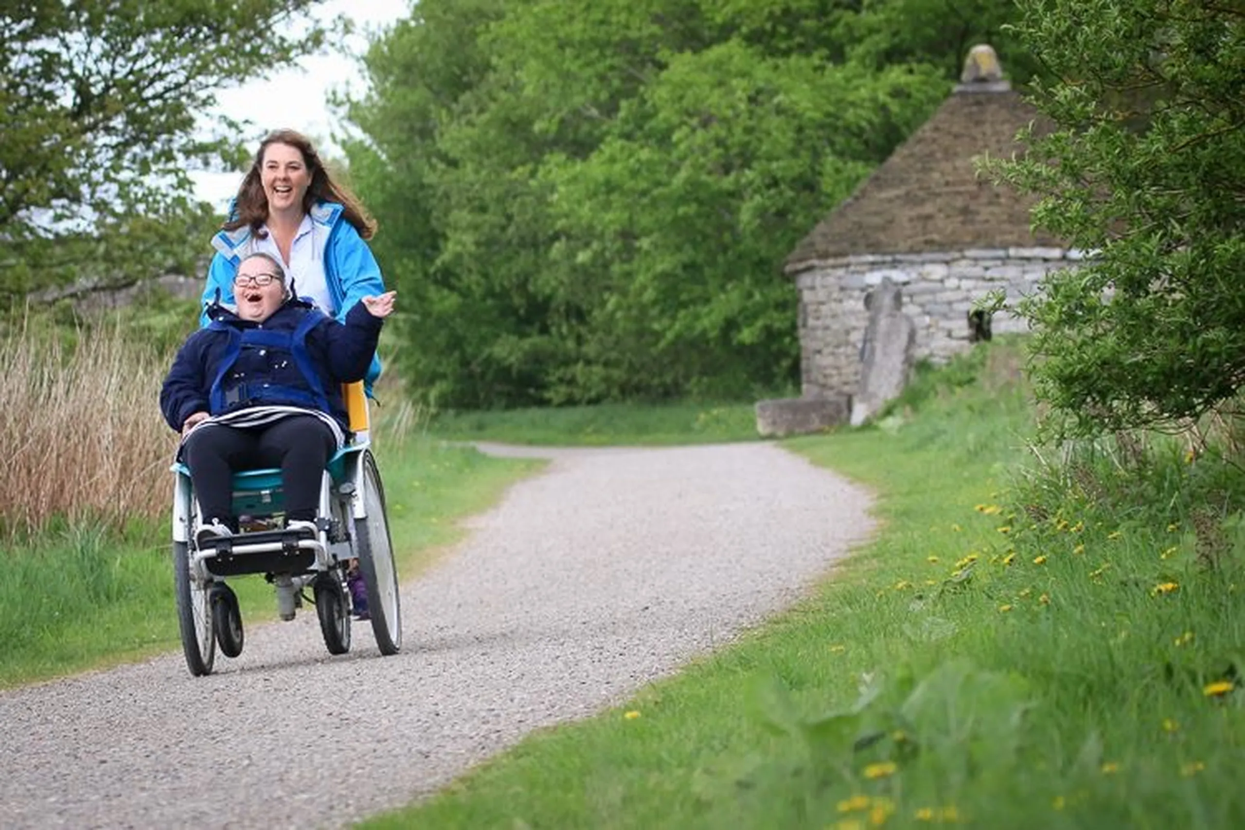 a woman in a wheelchair with a child near Havendale Accessible Holiday Cottage