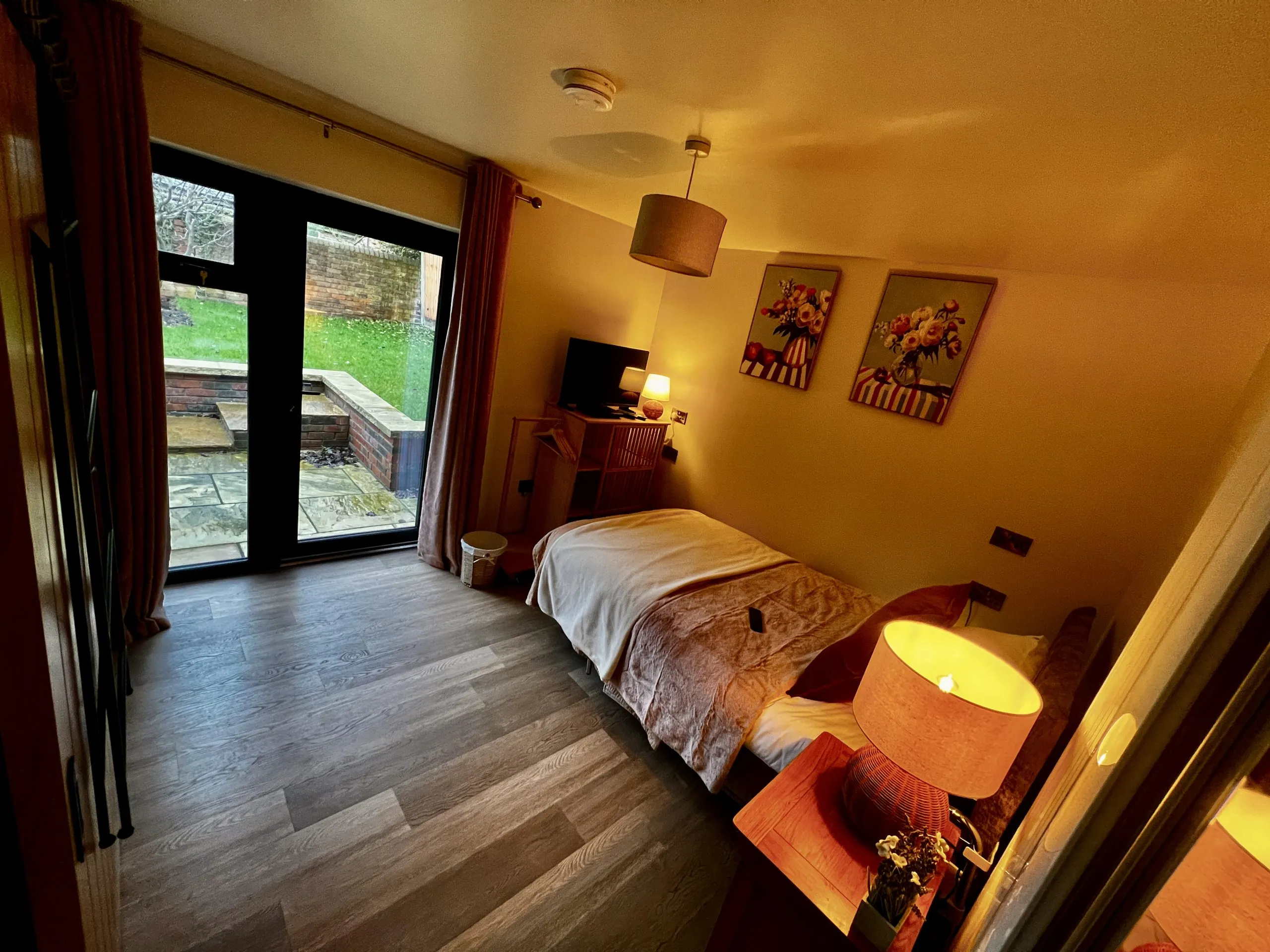 a bedroom with a bed and a door at Havendale Accessible Holiday Cottage