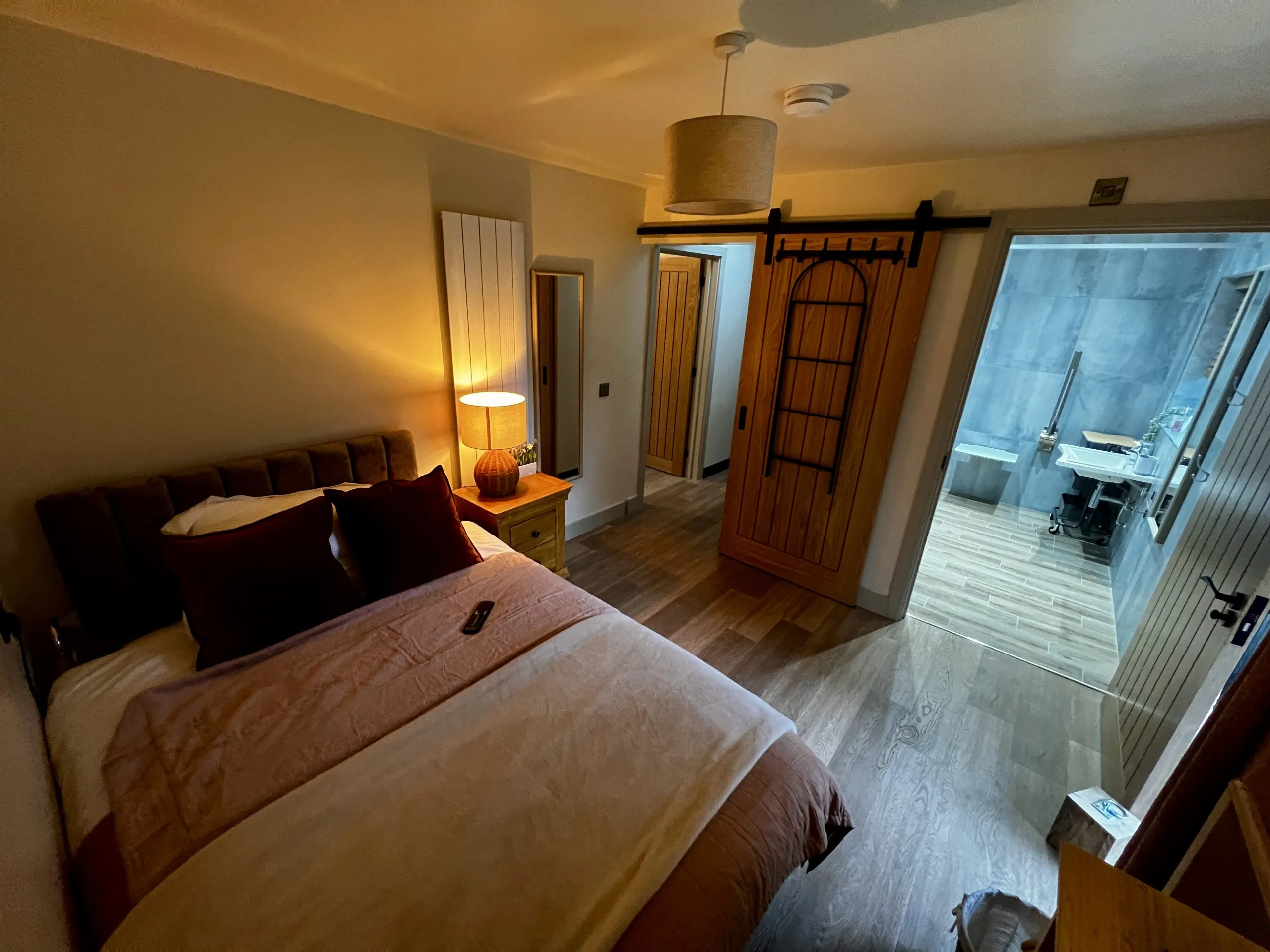 a bedroom with a bed and a window at Havendale Accessible Holiday Cottage
