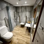 a bathroom with a toilet, sink, and shower at Havendale Accessible Holiday Cottage