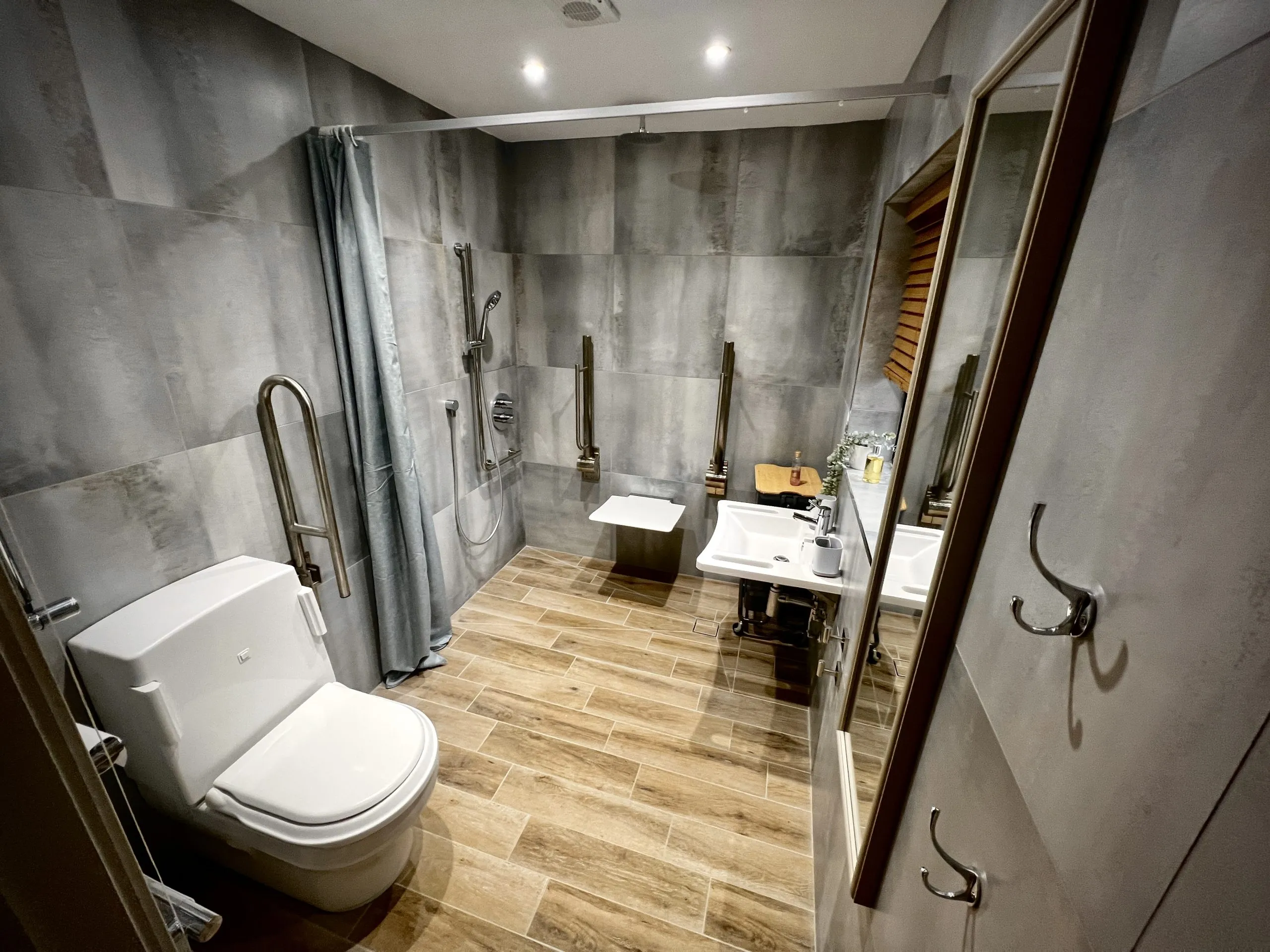 a bathroom with a toilet, sink, and shower at Havendale Accessible Holiday Cottage