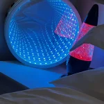a bed with a light on it and a lamp at Havendale Accessible Holiday Cottage