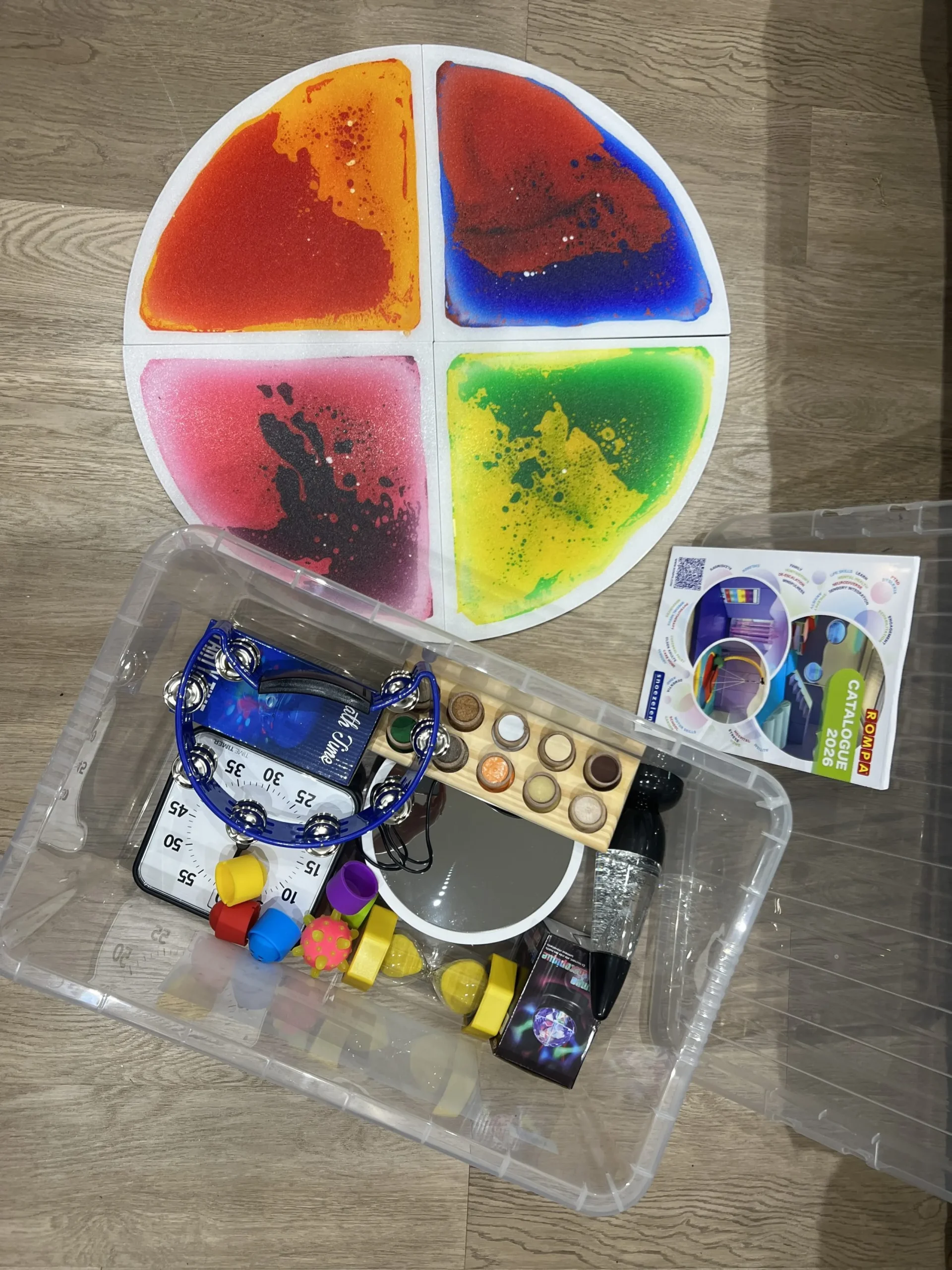 a plastic box containing various items and artwork at Havendale Accessible Holiday Cottage