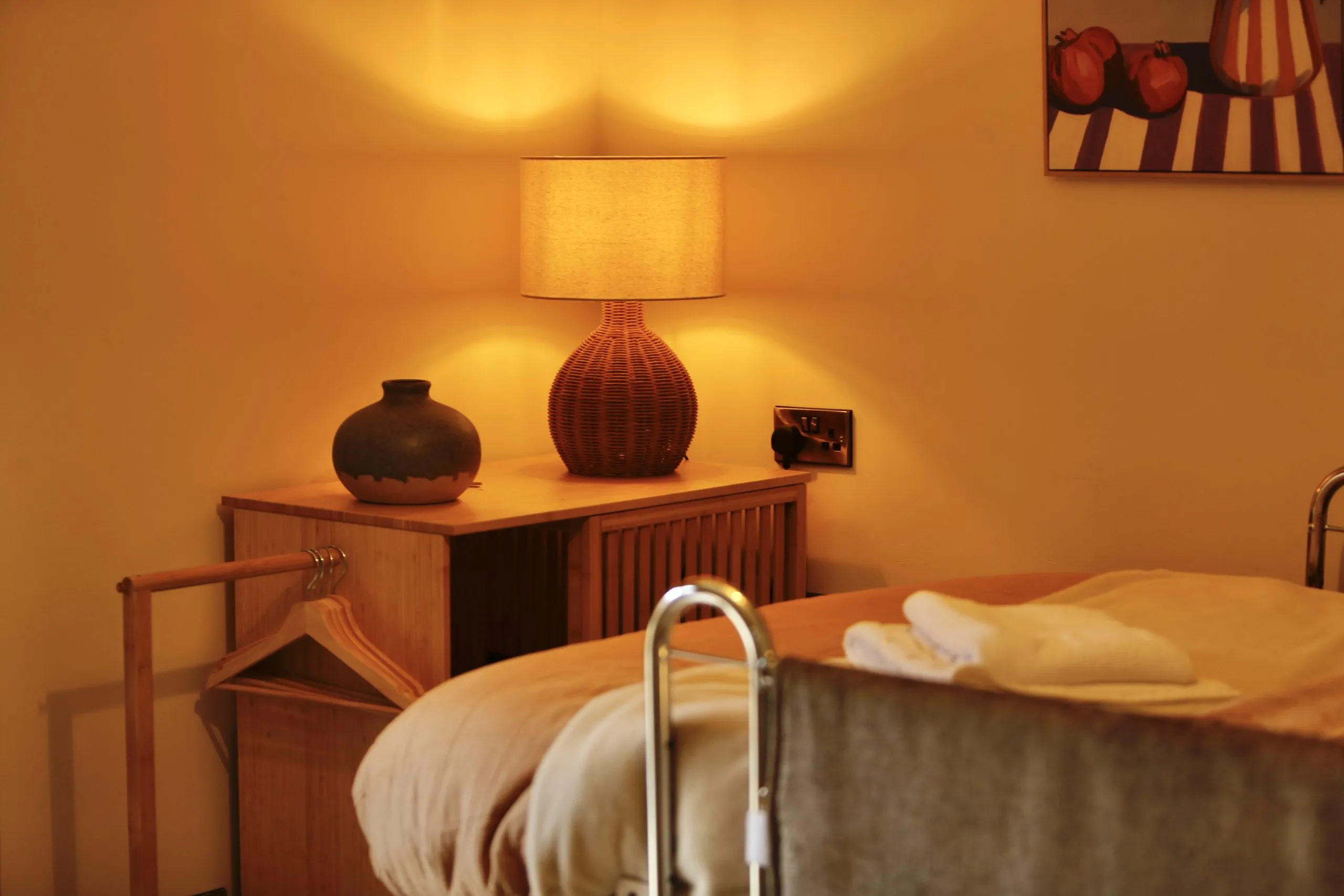 a bed with a lamp on top of it at Havendale Accessible Holiday Cottage