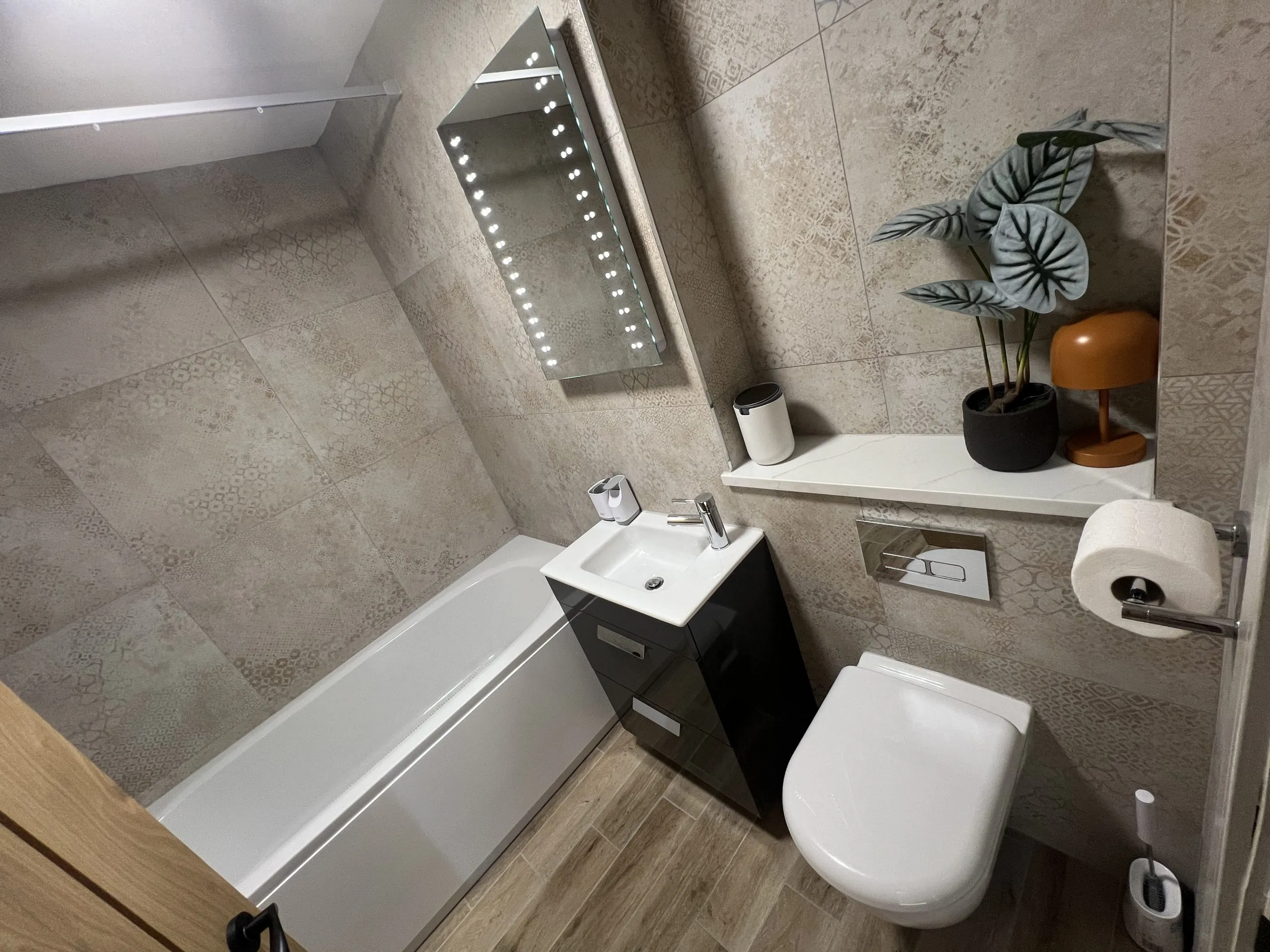 a bathroom with a toilet, sink and mirror at Havendale Accessible Holiday Cottage