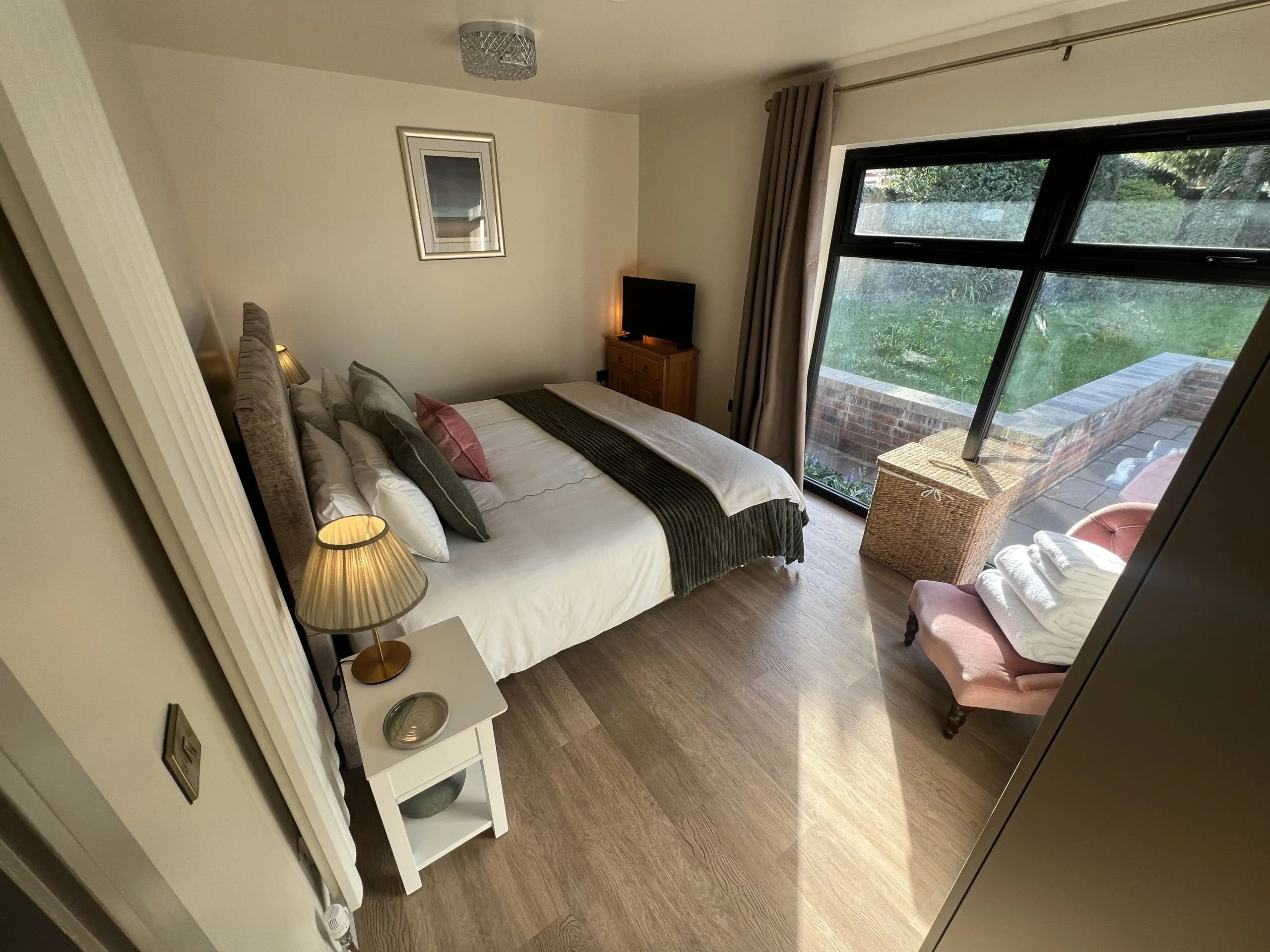 a bedroom with a bed and a window at Havendale Accessible Holiday Cottage