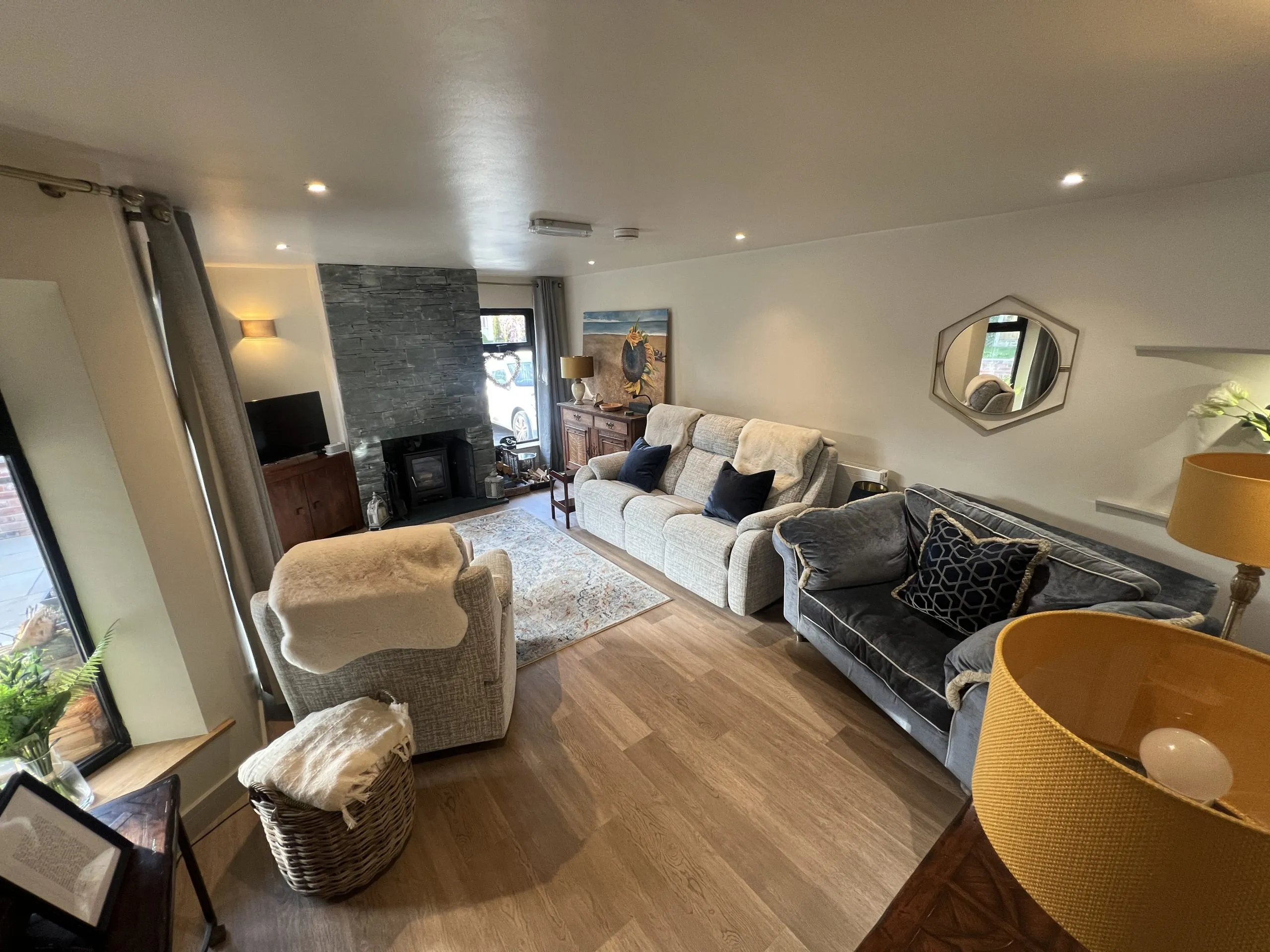 a living room with a sofa, chair, and television at Havendale Accessible Holiday Cottage