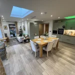 a dining room with a wooden table and chairs at Havendale Accessible Holiday Cottage