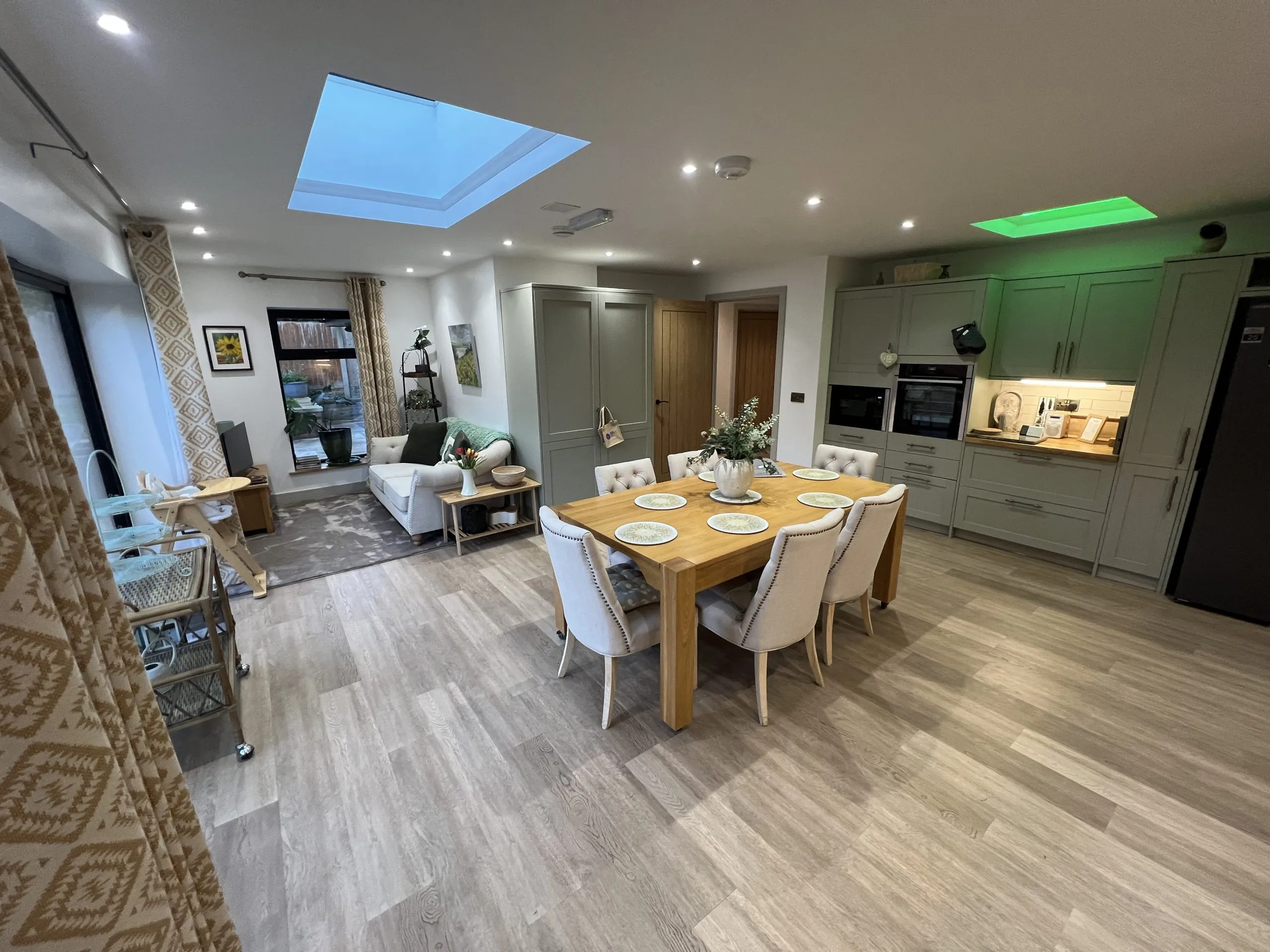 a dining room with a wooden table and chairs at Havendale Accessible Holiday Cottage