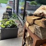a pile of wood sitting on a patio at Havendale Accessible Holiday Cottage