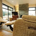 a living room with a couch and a television at Havendale Accessible Holiday Cottage