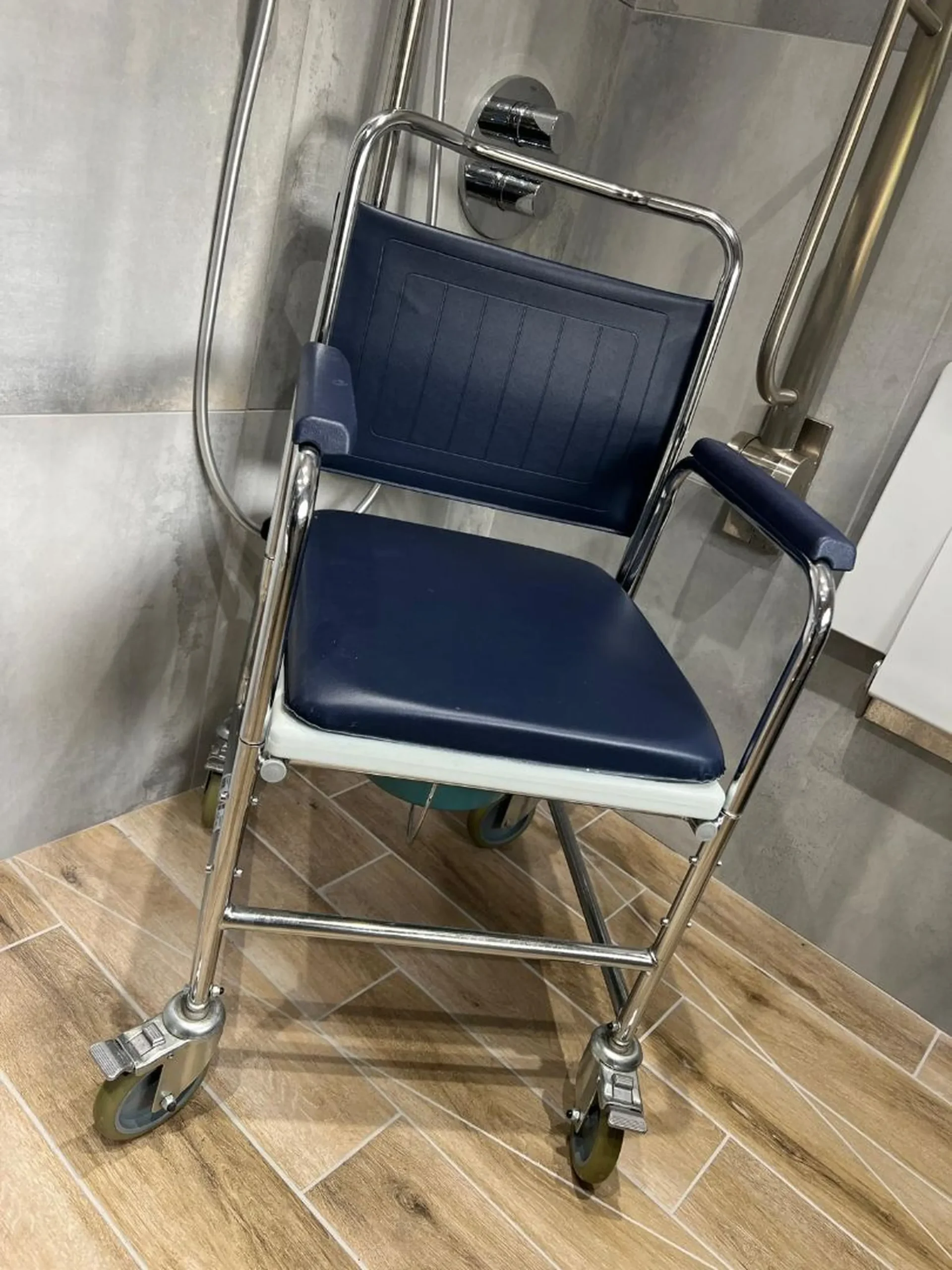 a blue and white shower seat with chrome legs at Havendale Accessible Holiday Cottage